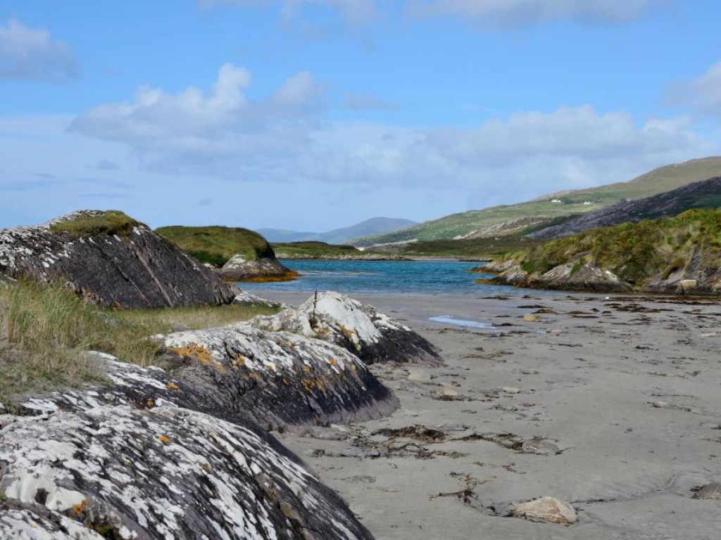 Lichen-painted rocks and pale sand at Derrynane Beach, County Kerry — a Blue Flag beach near the hotel.